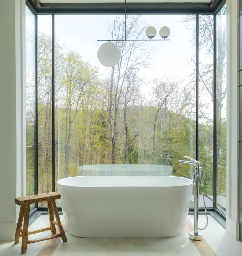 Double vanity bathroom with lake and forest view
