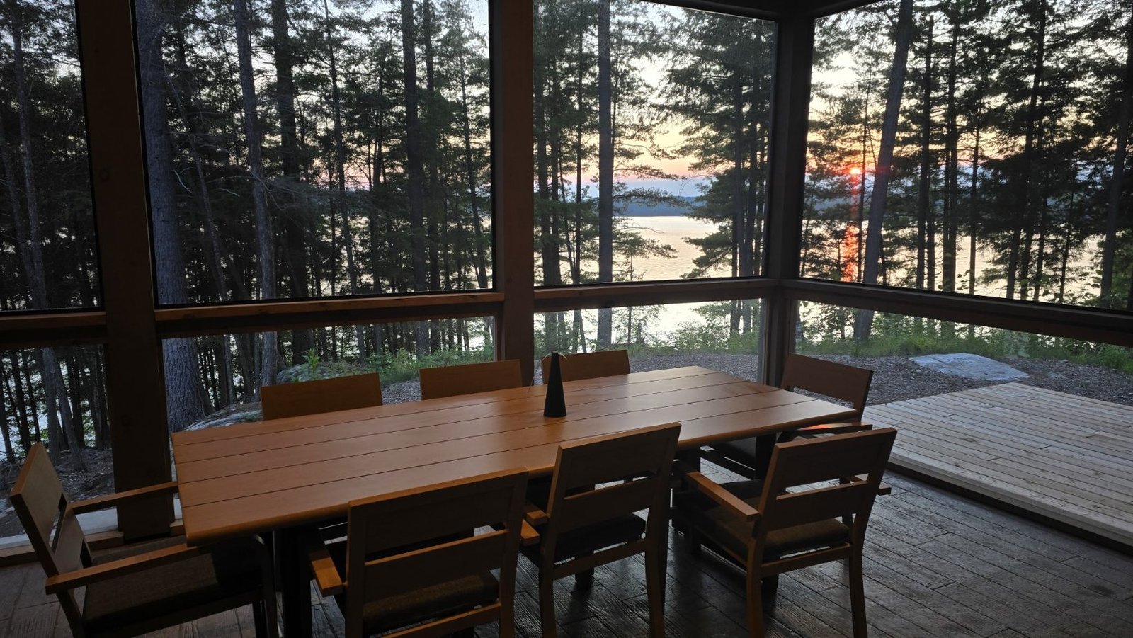 Sunset over the lake seen from the screened porch dining table